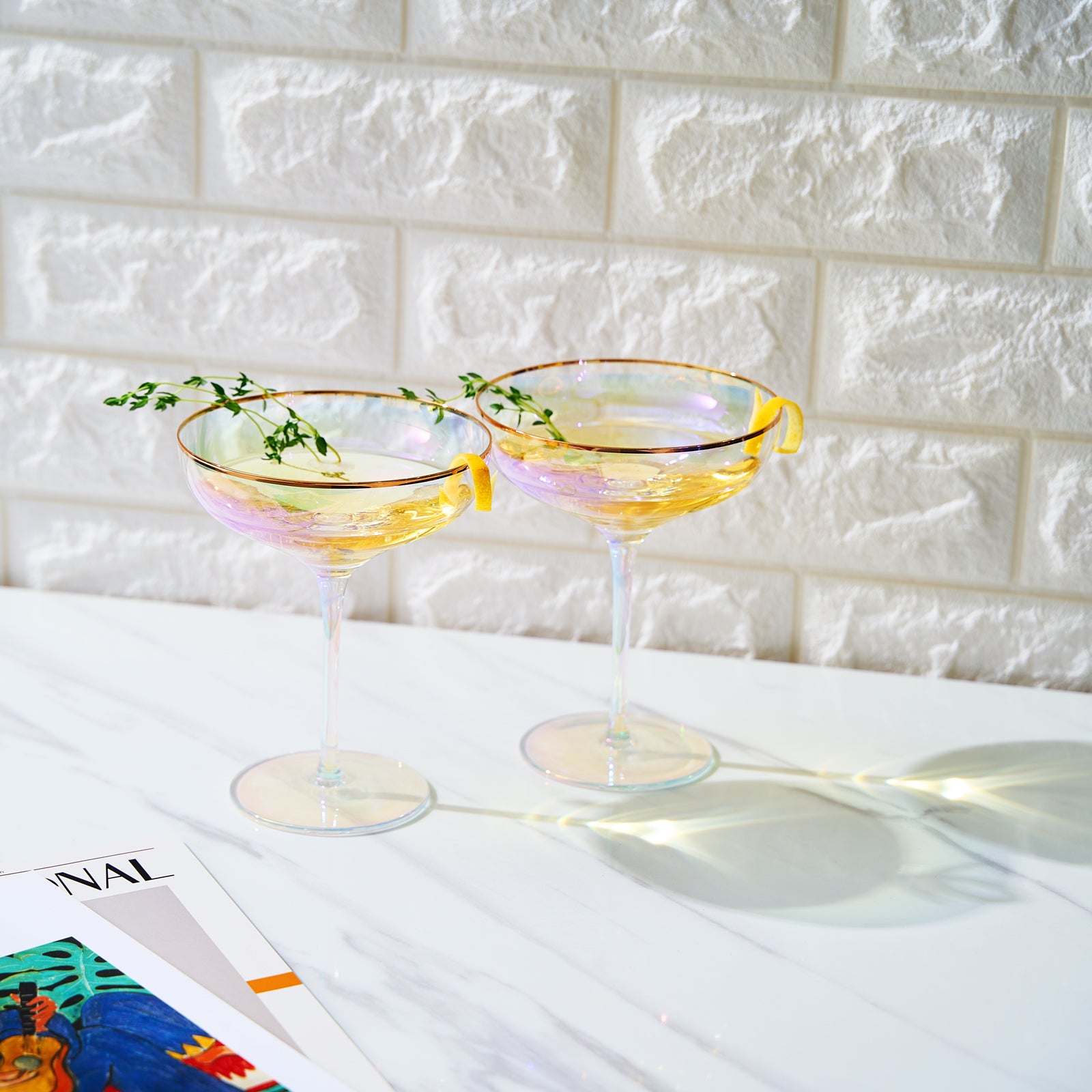 https://www.thewinesavant.com/cdn/shop/files/Gilded-rim-champagne-coupe-in-iridescent_-set-of-2_1800x1800.jpg?v=1698160718